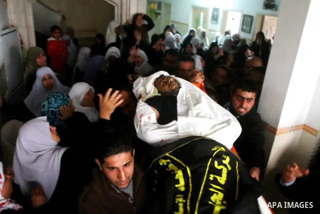 Palestinian relatives of Islamic Jihad militant Bassam El-Ejla, who was killed the night before along with another comrade in an Israeli air strike, mourn during his funeral in Gaza City on March 13, 2012. Israel and mil...