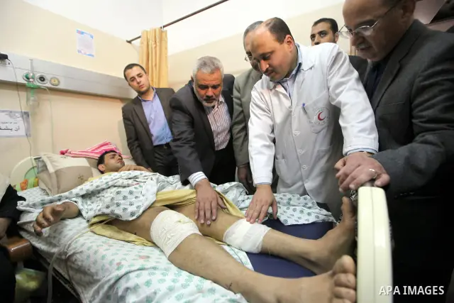 Palestinian Prime Minister in Gaza Strip, Ismail Haniyeh, visits a number of palestinians wounded of the Shifa hospital in Gaza City, on Mar. 13, 2012. Photo by Ahmed Shaat