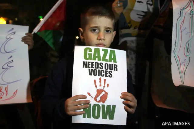 Palestinians take part in a protest in the center of the West Bank city of Ramallah on Mar. 13, 2012, to show their support for the Gaza Strip and against Israeli air strikes. Israel will continue air strikes against Gaz...