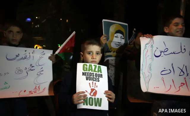 Palestinians take part in a protest in the center of the West Bank city of Ramallah on Mar. 13, 2012, to show their support for the Gaza Strip and against Israeli air strikes. Israel will continue air strikes against Gaz...