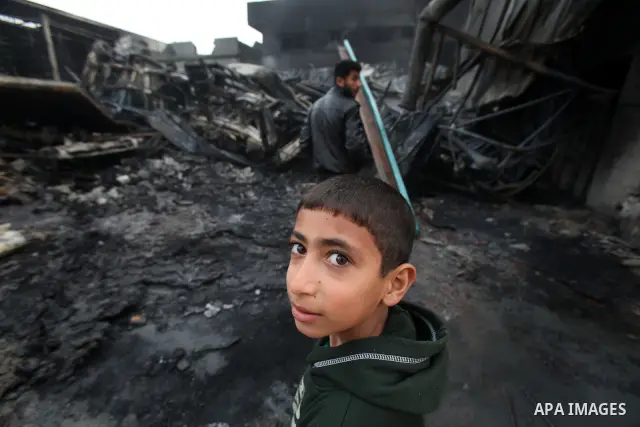 Palestinians inspect destroyed buildings on March 14, 2012, following an Israeli air strike on Gaza City. Israel and militants in Gaza began observing an Egyptian-brokered truce on March 13, after four days of violence,...
