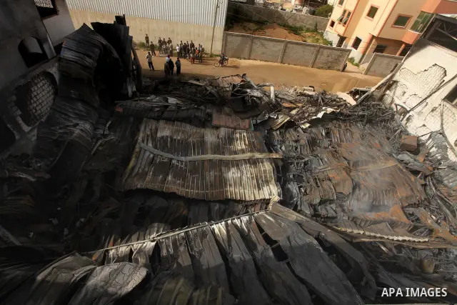 Palestinians inspect destroyed buildings on March 14, 2012, following an Israeli air strike on Gaza City. Israel and militants in Gaza began observing an Egyptian-brokered truce on March 13, after four days of violence,...