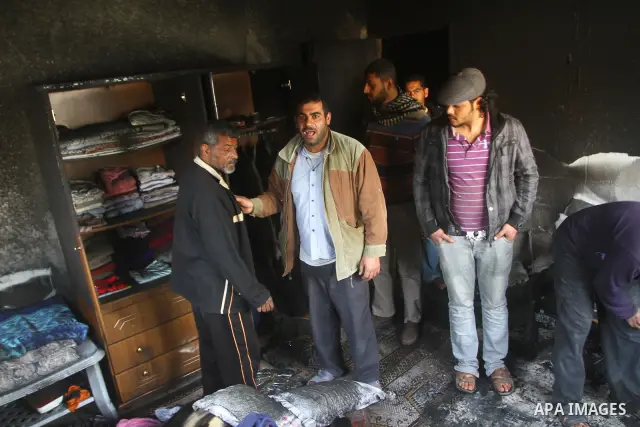 Palestinians inspect destroyed buildings on March 14, 2012, following an Israeli air strike on Gaza City. Israel and militants in Gaza began observing an Egyptian-brokered truce on March 13, after four days of violence,...