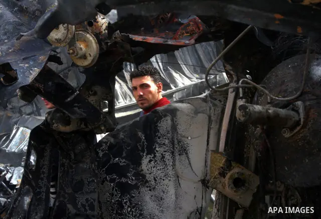 Palestinians inspect destroyed buildings on March 14, 2012, following an Israeli air strike on Gaza City. Israel and militants in Gaza began observing an Egyptian-brokered truce on March 13, after four days of violence,...
