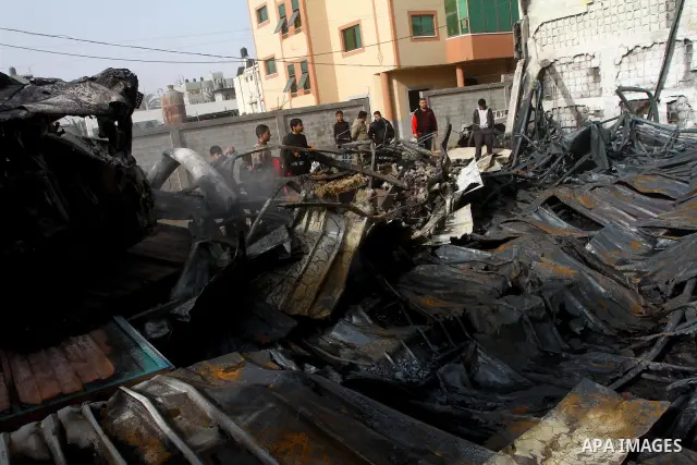 Palestinians inspect destroyed buildings on March 14, 2012, following an Israeli air strike on Gaza City. Israel and militants in Gaza began observing an Egyptian-brokered truce on March 13, after four days of violence,...