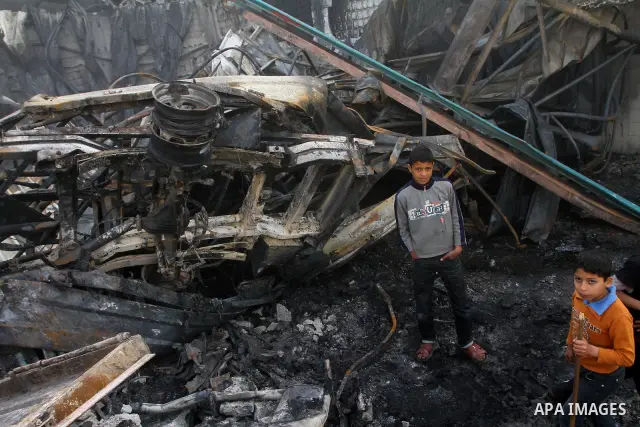 Palestinians inspect destroyed buildings on March 14, 2012, following an Israeli air strike on Gaza City. Israel and militants in Gaza began observing an Egyptian-brokered truce on March 13, after four days of violence,...