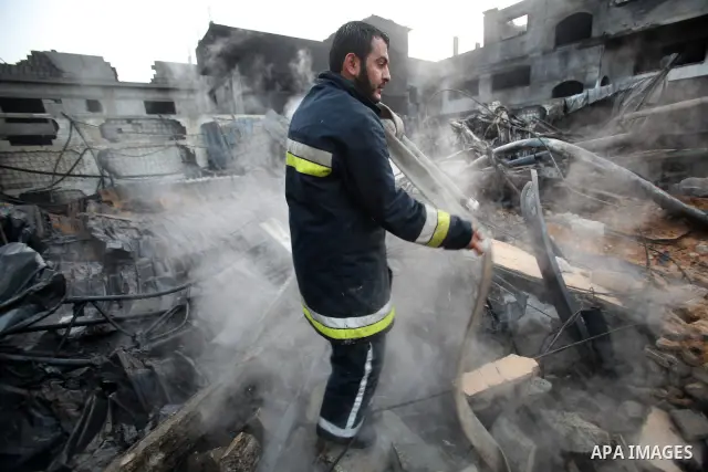 Palestinian firemen extinguish a fire at a building on March 14, 2012, after an Israeli air strike on Gaza City. Israel and militants in Gaza began observing an Egyptian-brokered truce on March 13, after four days of vio...