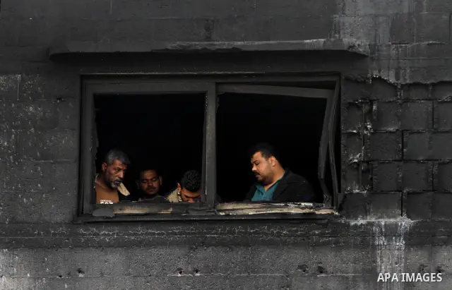 Palestinians inspect destroyed buildings on March 14, 2012, following an Israeli air strike on Gaza City. Israel and militants in Gaza began observing an Egyptian-brokered truce on March 13, after four days of violence,...