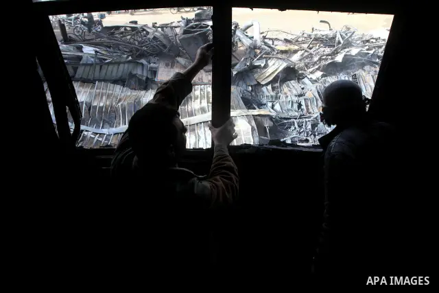 Palestinians inspect destroyed buildings on March 14, 2012, following an Israeli air strike on Gaza City. Israel and militants in Gaza began observing an Egyptian-brokered truce on March 13, after four days of violence,...