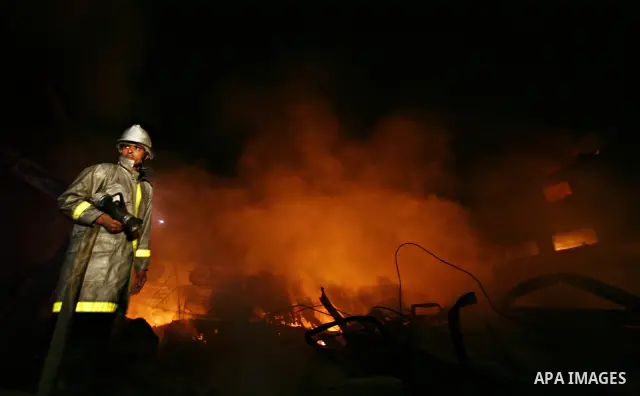 Palestinian fire fighters try to extinguish a blaze at a burning factory after an Israeli missile strike in the east of Gaza Strip on 14 March 2012. A fragile truce appeared to be taking hold between Israel and Palestini...