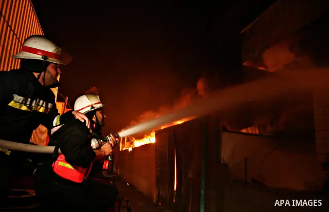 Palestinian fire fighters try to extinguish a blaze at a burning factory after an Israeli missile strike in the east of Gaza Strip on 14 March 2012. A fragile truce appeared to be taking hold between Israel and Palestini...