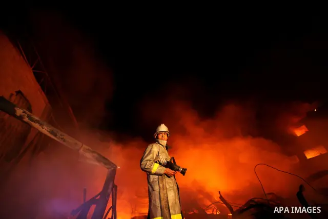 Palestinian fire fighters try to extinguish a blaze at a burning factory after an Israeli missile strike in the east of Gaza Strip on 14 March 2012. A fragile truce appeared to be taking hold between Israel and Palestini...