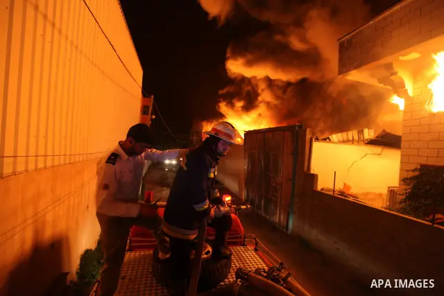 Palestinian fire fighters try to extinguish a blaze at a burning factory after an Israeli missile strike in the east of Gaza Strip on 14 March 2012. A fragile truce appeared to be taking hold between Israel and Palestini...