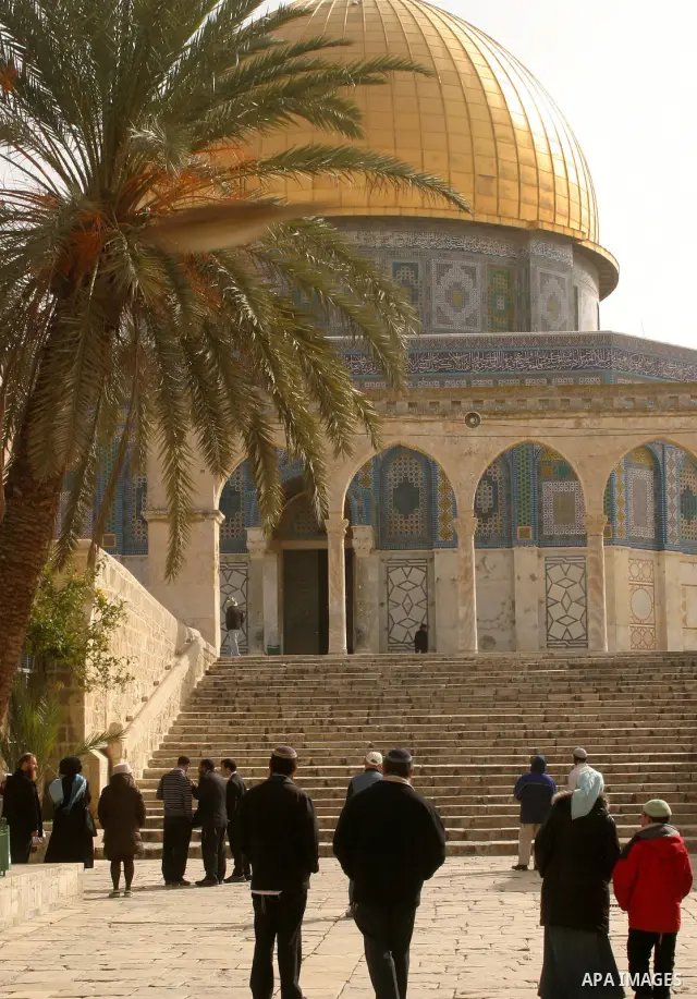 Palestinians and Jewish settler look to the dome of the rock at Al-Aqsa mosque in the old city of Jerusalem on Mar. 14, 2012. Photo by Mahfouz Abu Turk