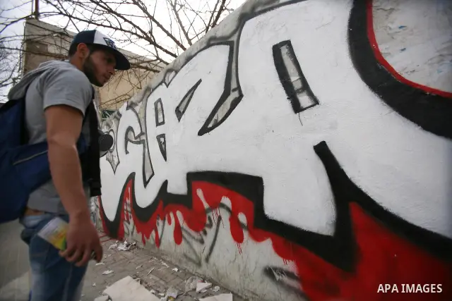 Palestinian students paint graffiti depicting word "Gaza" to show their support for the Gaza Strip and against Israeli air strikes, in the West Bank city of Hebron, on March 15, 2012. Photo by Mamoun Wazwaz.