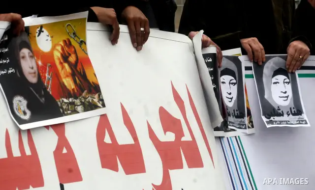 Palestinian protestors demonstrate at the entrance to Ofer Prison near Ramallah in the Occupied West Bank to support female prisoner Hanaa al-Shalabi (portrait) who was freed in a prisoner swap with Israel but was re-arr...