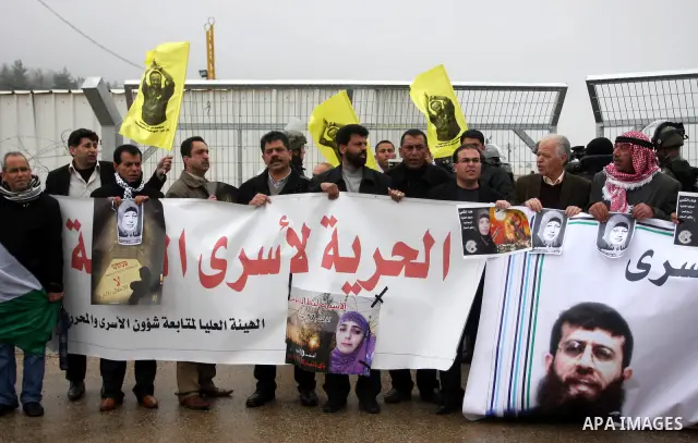 Palestinian protestors demonstrate at the entrance to Ofer Prison near Ramallah in the Occupied West Bank to support female prisoner Hanaa al-Shalabi (portrait) who was freed in a prisoner swap with Israel but was re-arr...