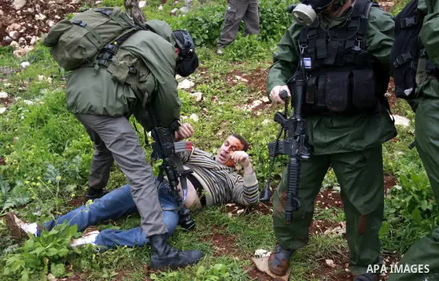 Israeli security forces arrest a palestinian ,during a protest in the village of Kufr Qaddum near the Israeli settlement of Kdumim, in the northern West Bank, Friday,March 16, 2012. Photo by Wagdi Eshtayah
