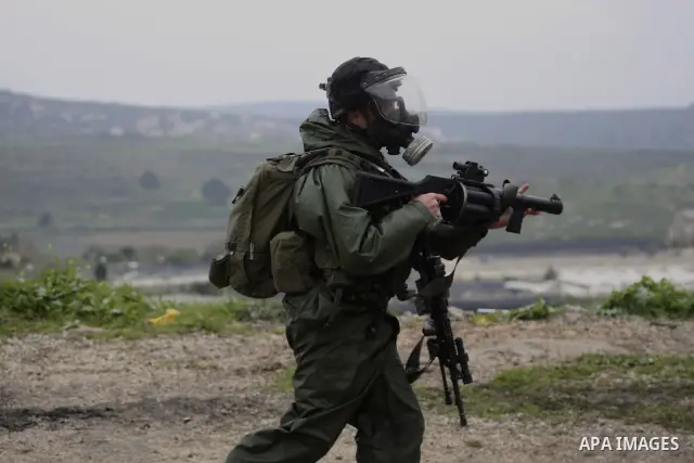 Israeli border police run towards Palestinian demonstrators, during a protest in the village of Kufr Qaddum near the Israeli settlement of Kdumim, in the northern West Bank, Friday,March 16, 2012. Photo by Wagdi Eshtayah
