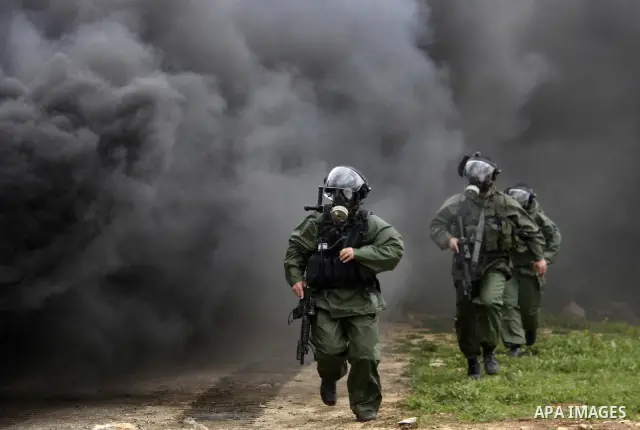 Israeli border police run towards Palestinian demonstrators, during a protest in the village of Kufr Qaddum near the Israeli settlement of Kdumim, in the northern West Bank, Friday,March 16, 2012. Photo by Wagdi Eshtayah