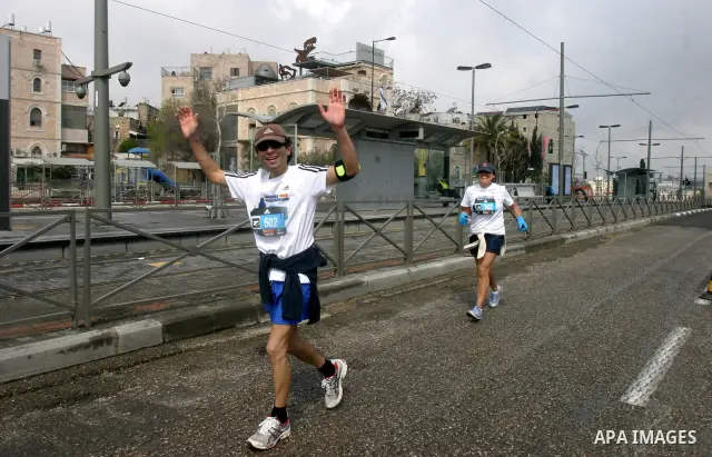 Marathon runners leave the Old City of Jerusalem during the Jerusalem Marathon, in Jerusalem, 16 March 2012. It is the second year the Jerusalem Marathon has been organized and the three events, a full marathon, a half m...