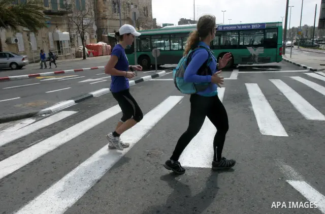 Marathon runners leave the Old City of Jerusalem during the Jerusalem Marathon, in Jerusalem, 16 March 2012. It is the second year the Jerusalem Marathon has been organized and the three events, a full marathon, a half m...