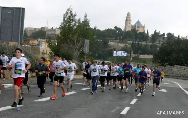 Marathon runners leave the Old City of Jerusalem during the Jerusalem Marathon, in Jerusalem, 16 March 2012. It is the second year the Jerusalem Marathon has been organized and the three events, a full marathon, a half m...