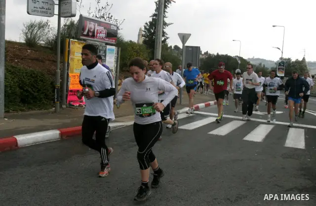 Marathon runners leave the Old City of Jerusalem during the Jerusalem Marathon, in Jerusalem, 16 March 2012. It is the second year the Jerusalem Marathon has been organized and the three events, a full marathon, a half m...