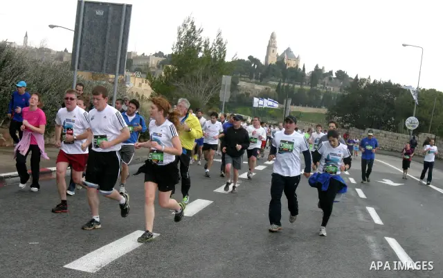 Marathon runners leave the Old City of Jerusalem during the Jerusalem Marathon, in Jerusalem, 16 March 2012. It is the second year the Jerusalem Marathon has been organized and the three events, a full marathon, a half m...