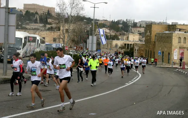 Marathon runners leave the Old City of Jerusalem during the Jerusalem Marathon, in Jerusalem, 16 March 2012. It is the second year the Jerusalem Marathon has been organized and the three events, a full marathon, a half m...