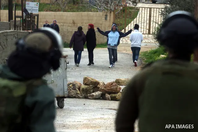 Israeli soldiers march during clashes with Palestinian and foreign activists in the West Bank village of Nabi Saleh, near Ramallah, on March 16, 2012 following a protest against Palestinian land confiscation to build the...