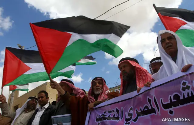 Palestinians attend a rally in front of the Rafah border crossing with Egypt on March 17, 2012, during a sit-in Rafah demanding Egypt provide the Gaza Strip with electricity and diesel. The Palestinian energy authority i...