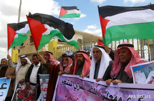 Palestinians attend a rally in front of the Rafah border crossing with Egypt on March 17, 2012, during a sit-in Rafah demanding Egypt provide the Gaza Strip with electricity and diesel. The Palestinian energy authority i...