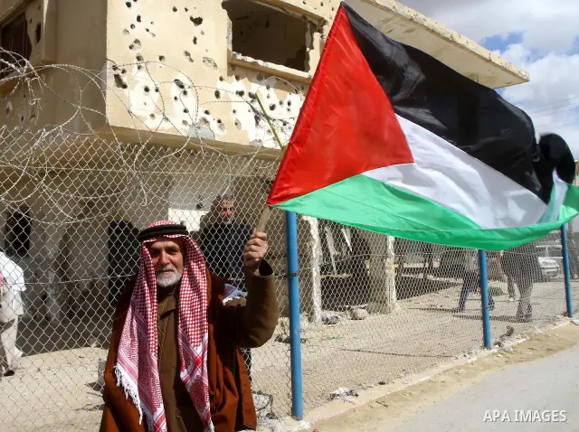 Palestinians attend a rally in front of the Rafah border crossing with Egypt on March 17, 2012, during a sit-in Rafah demanding Egypt provide the Gaza Strip with electricity and diesel. The Palestinian energy authority i...