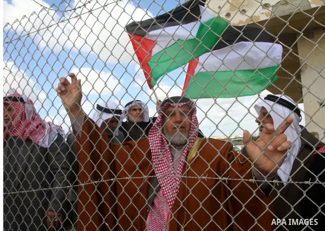Palestinians attend a rally in front of the Rafah border crossing with Egypt on March 17, 2012, during a sit-in Rafah demanding Egypt provide the Gaza Strip with electricity and diesel. The Palestinian energy authority i...