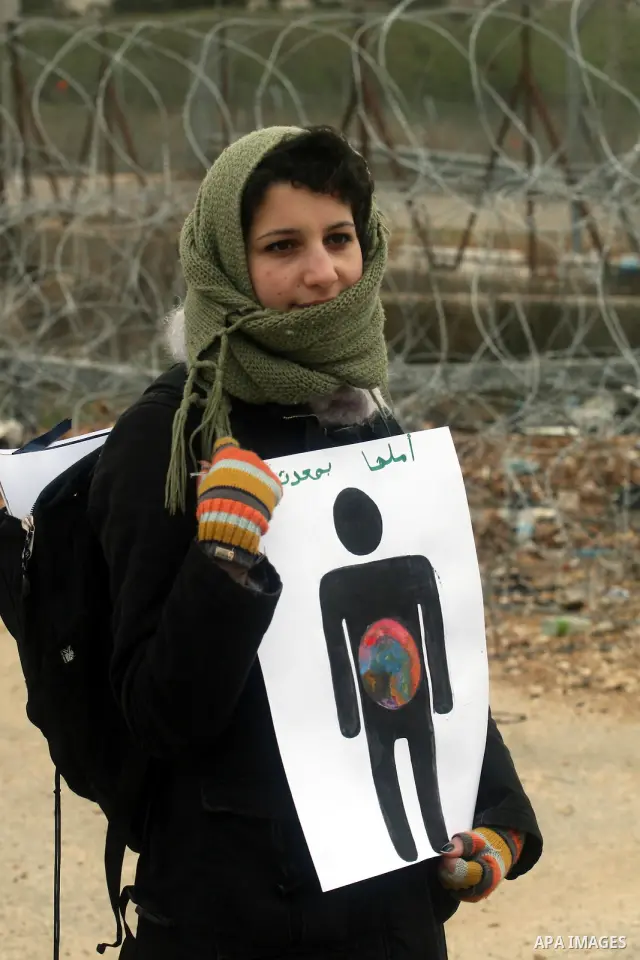 Palestinian protestors demonstrate at the entrance to Ofer Prison near Ramallah in the Occupied West Bank to support female prisoner Hanaa al-Shalabi (portrait) who was freed in a prisoner swap with Israel but was re-arr...