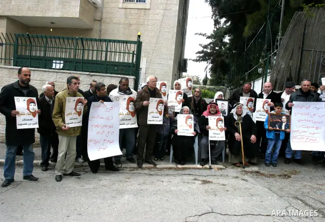 Palestinians hold portraits of jailed compatriot Hana Shalabi, a female Palestinian prisoner jailed in Israel who has been on hunger strike for 31 days, in Jerusalem, 17 March 2012. Palestinian sources said that Shalabi...