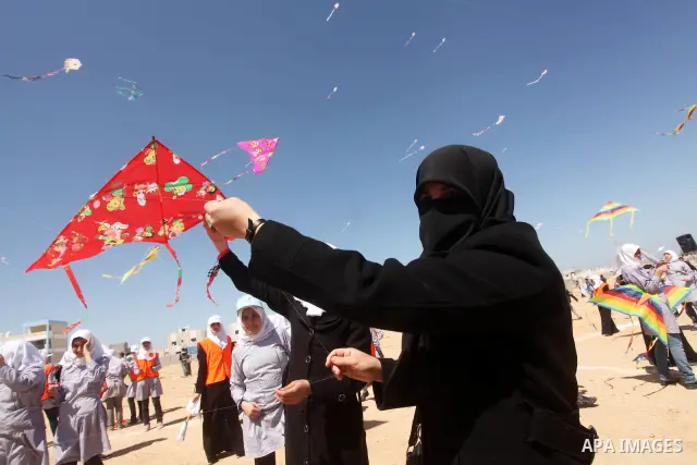 Palestinian children fly kites to show their solidarity with the Japanese people near a Japanese-funded housing project in Khan Younis in the southern Gaza Strip March 18, 2012. The event was organized by the United Nati...