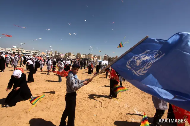 Palestinian children fly kites to show their solidarity with the Japanese people near a Japanese-funded housing project in Khan Younis in the southern Gaza Strip March 18, 2012. The event was organized by the United Nati...