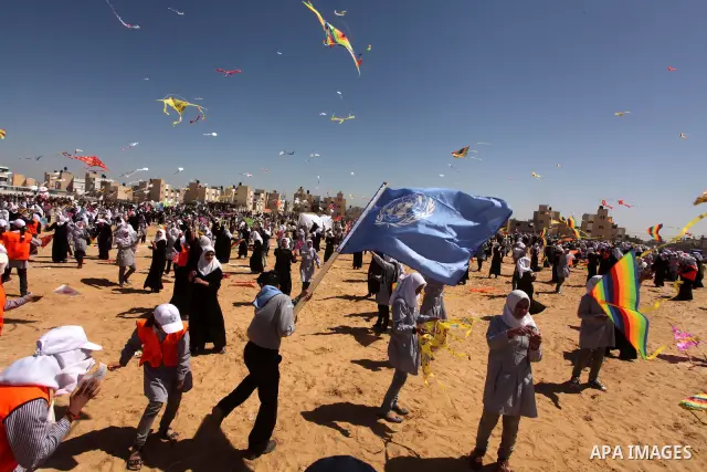 Palestinian children fly kites to show their solidarity with the Japanese people near a Japanese-funded housing project in Khan Younis in the southern Gaza Strip March 18, 2012. The event was organized by the United Nati...