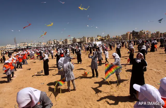 Palestinian children fly kites to show their solidarity with the Japanese people near a Japanese-funded housing project in Khan Younis in the southern Gaza Strip March 18, 2012. The event was organized by the United Nati...