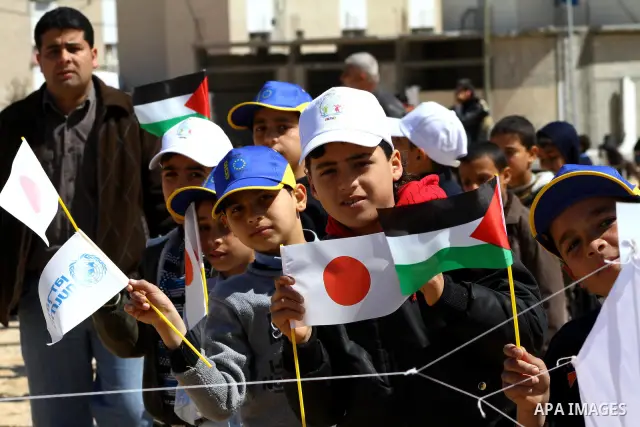 Palestinian children fly kites to show their solidarity with the Japanese people near a Japanese-funded housing project in Khan Younis in the southern Gaza Strip March 18, 2012. The event was organized by the United Nati...