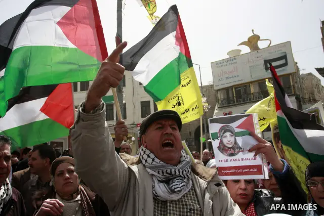 Palestinian women hold portraits of jailed compatriot Hana Shalabi, a female Palestinian prisoner jailed in Israel who has been on hunger strike for 33 days, outside the Red Cross building in the West Bank city of Nablus...