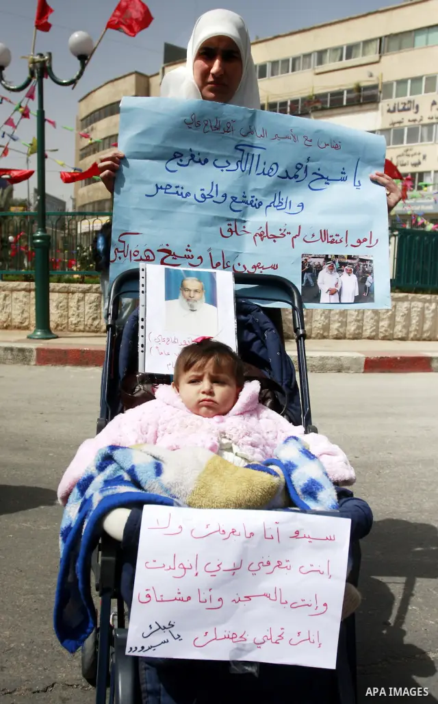 Palestinian women hold portraits of jailed compatriot Hana Shalabi, a female Palestinian prisoner jailed in Israel who has been on hunger strike for 33 days, outside the Red Cross building in the West Bank city of Nablus...