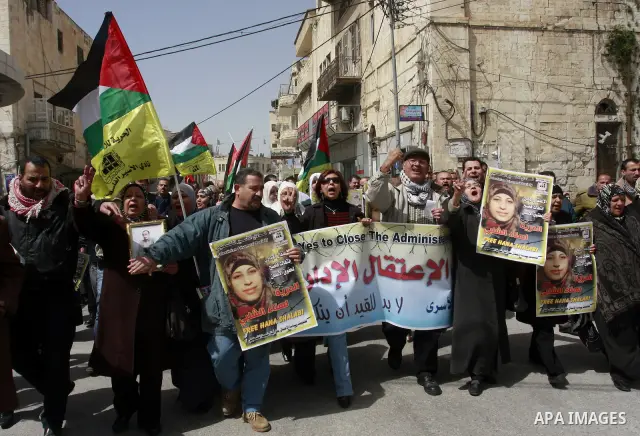 Palestinian women hold portraits of jailed compatriot Hana Shalabi, a female Palestinian prisoner jailed in Israel who has been on hunger strike for 33 days, outside the Red Cross building in the West Bank city of Nablus...
