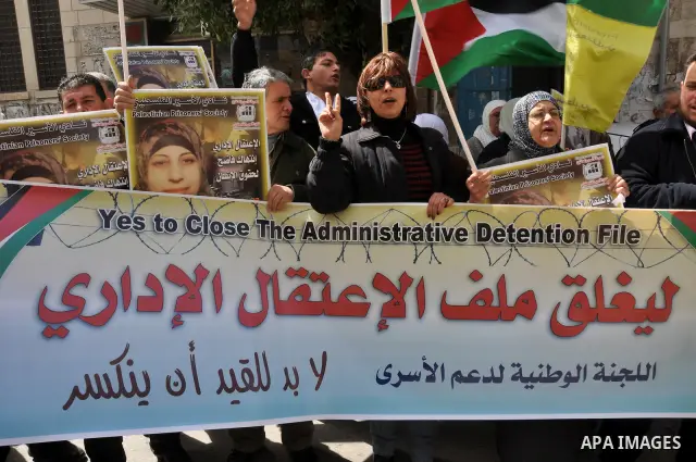 Palestinian women hold portraits of jailed compatriot Hana Shalabi, a female Palestinian prisoner jailed in Israel who has been on hunger strike for 33 days, outside the Red Cross building in the West Bank city of Nablus...