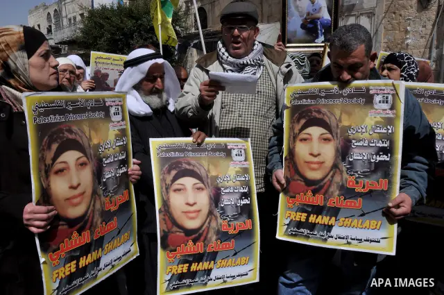 Palestinian women hold portraits of jailed compatriot Hana Shalabi, a female Palestinian prisoner jailed in Israel who has been on hunger strike for 33 days, outside the Red Cross building in the West Bank city of Nablus...