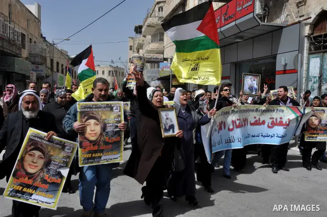 Palestinian women hold portraits of jailed compatriot Hana Shalabi, a female Palestinian prisoner jailed in Israel who has been on hunger strike for 33 days, outside the Red Cross building in the West Bank city of Nablus...