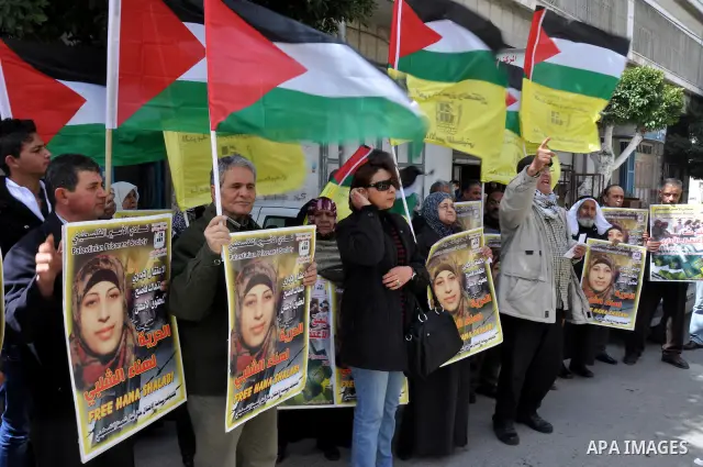 Palestinian women hold portraits of jailed compatriot Hana Shalabi, a female Palestinian prisoner jailed in Israel who has been on hunger strike for 33 days, outside the Red Cross building in the West Bank city of Nablus...