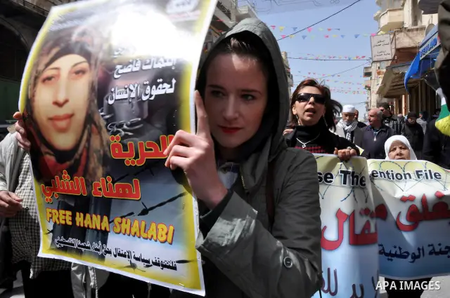 Palestinian women hold portraits of jailed compatriot Hana Shalabi, a female Palestinian prisoner jailed in Israel who has been on hunger strike for 33 days, outside the Red Cross building in the West Bank city of Nablus...